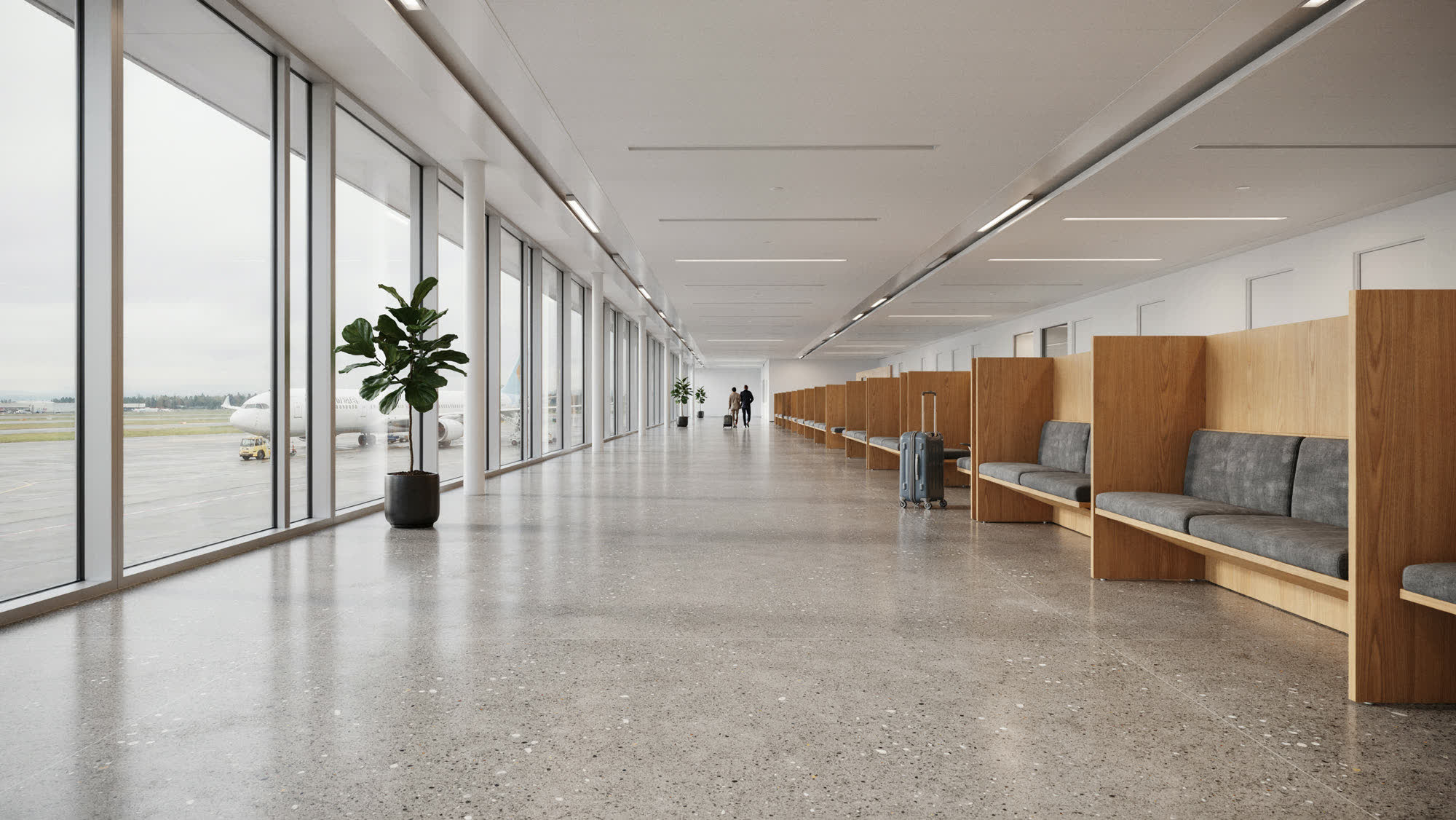 An airport terminal concourse with gate seating beside tall windows