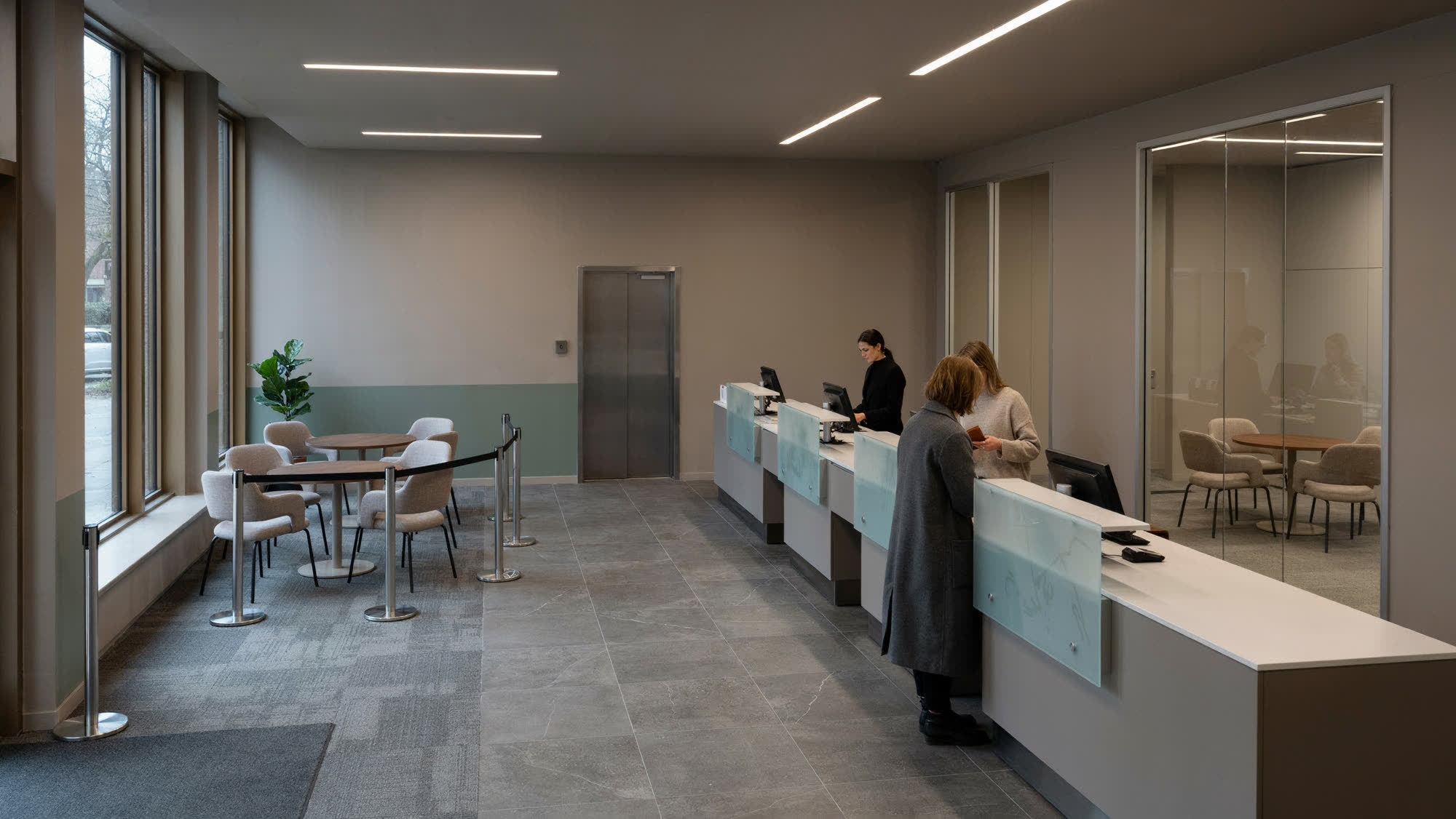 A bank branch interior with a teller line and private consultation rooms