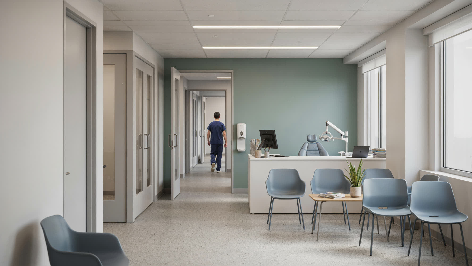 A dental and medical practice waiting area with an exam-room corridor beyond