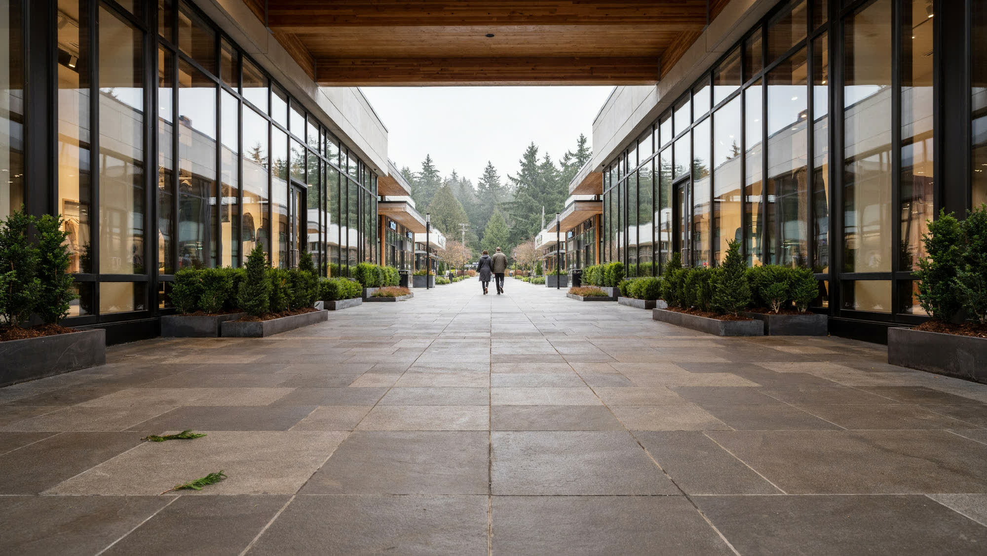 An open-air retail center walkway under a timber canopy