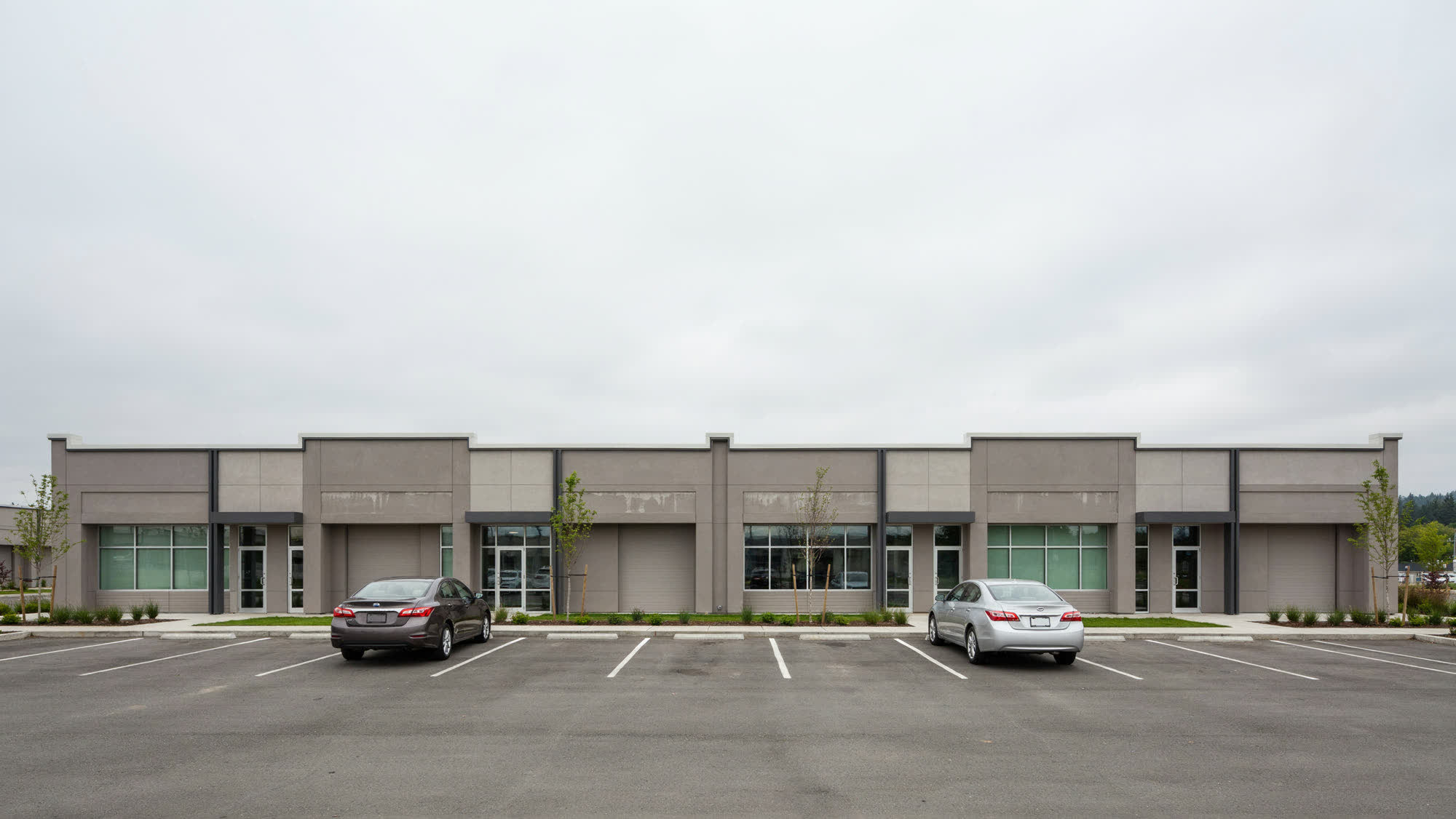A light-industrial business park with office storefronts and service doors