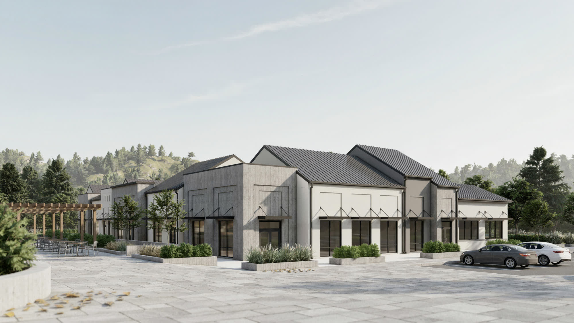A suburban retail plaza with metal roofs, storefronts and a pergola patio
