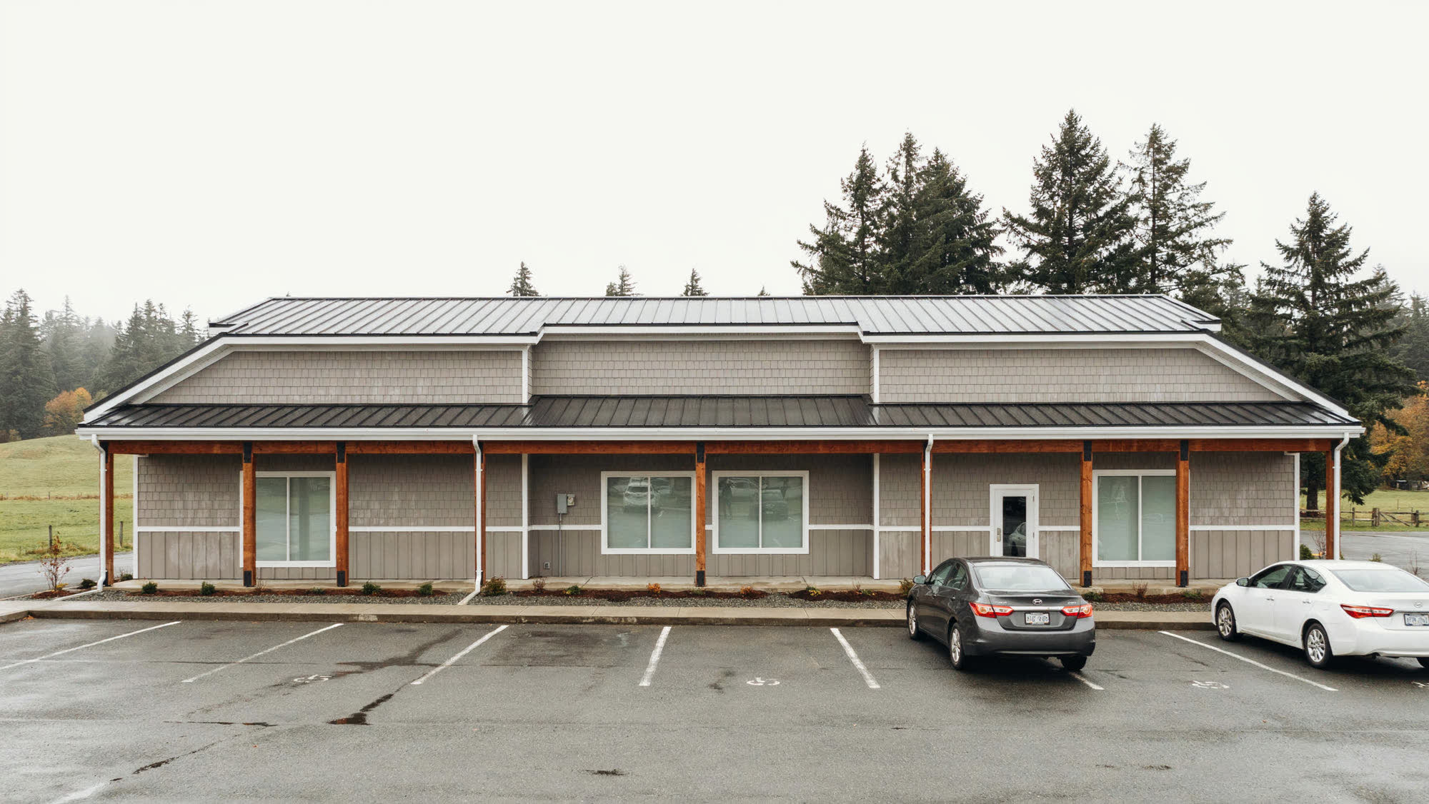 A single-story commercial building with storefront suites and a covered walkway