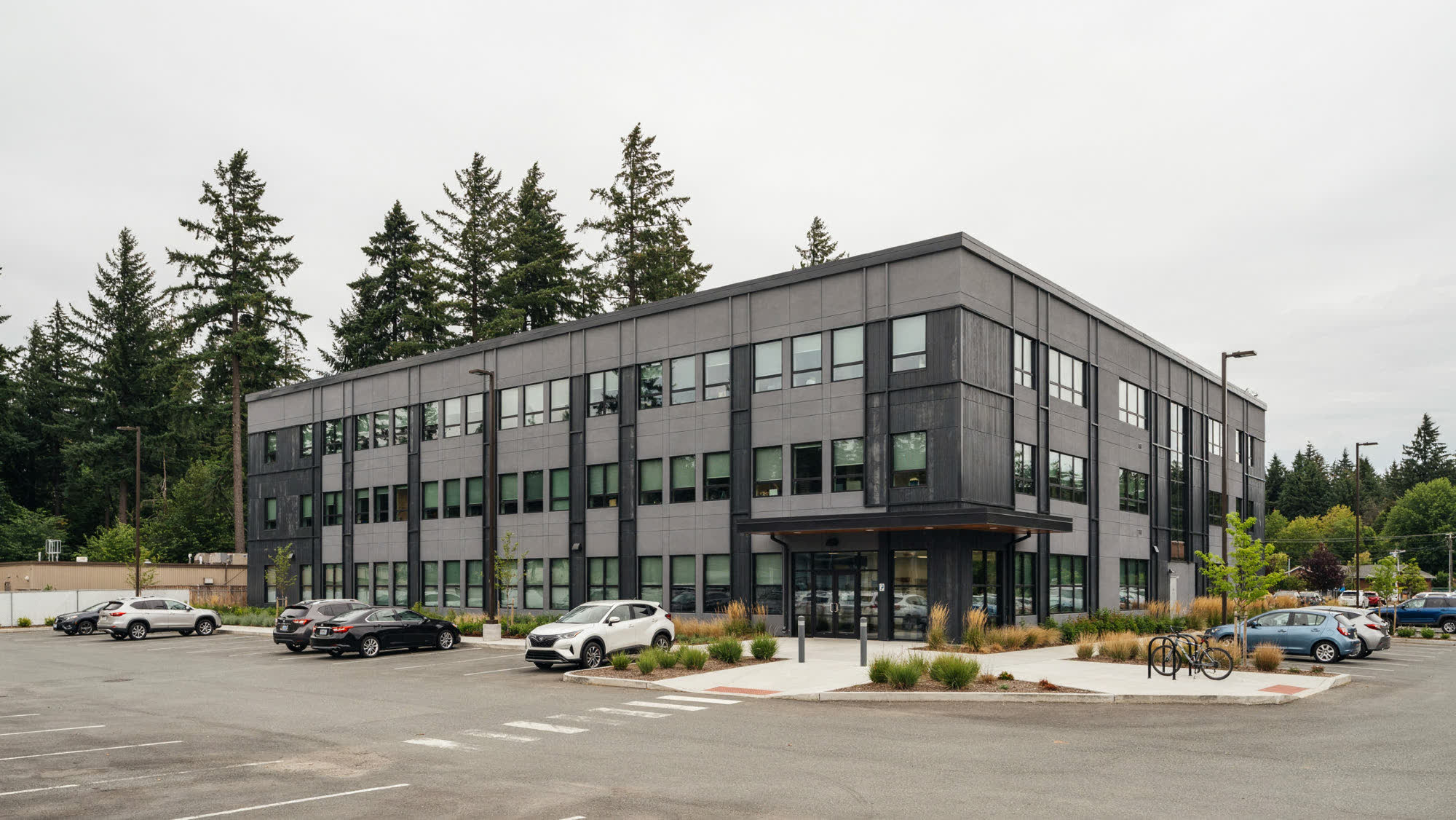 A three-story professional office building with a covered entrance and parking