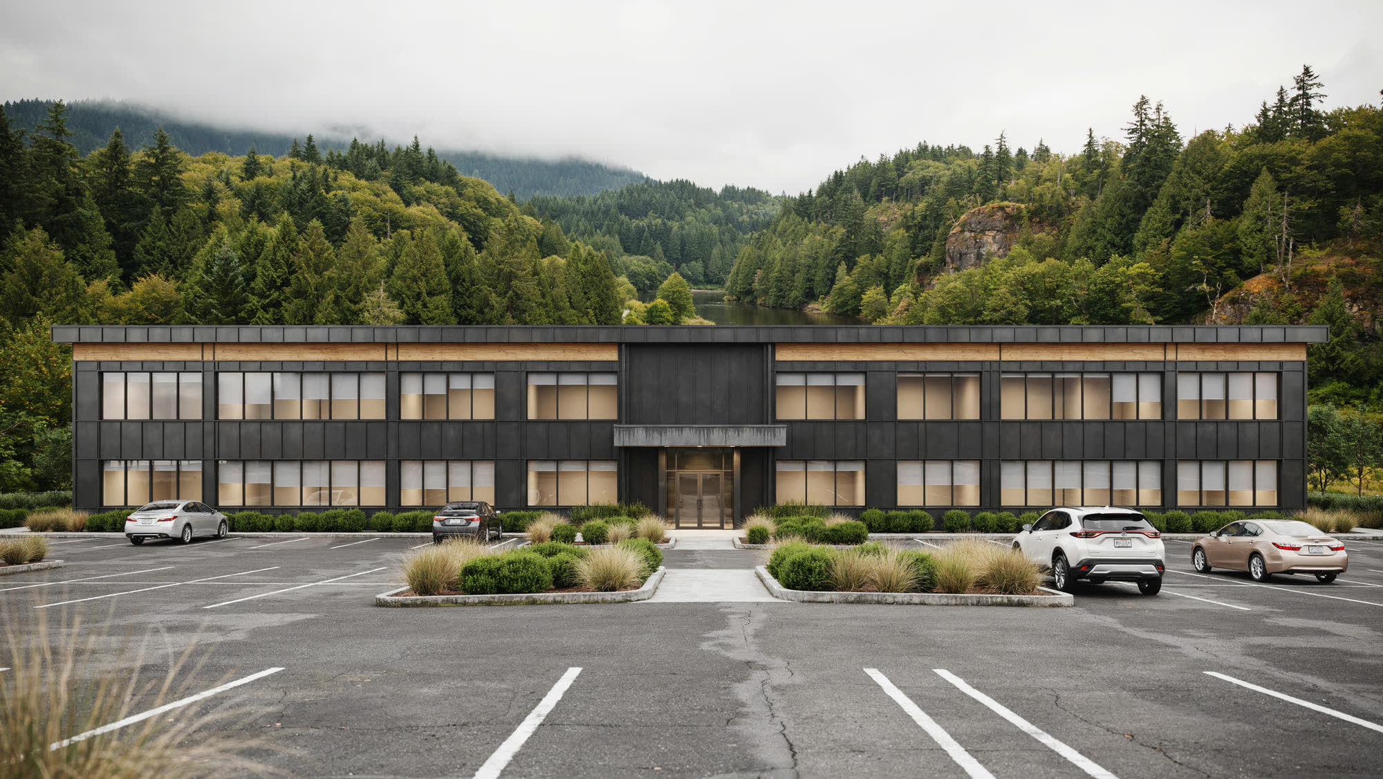 A two-story business-park office building with forested gorge hills behind