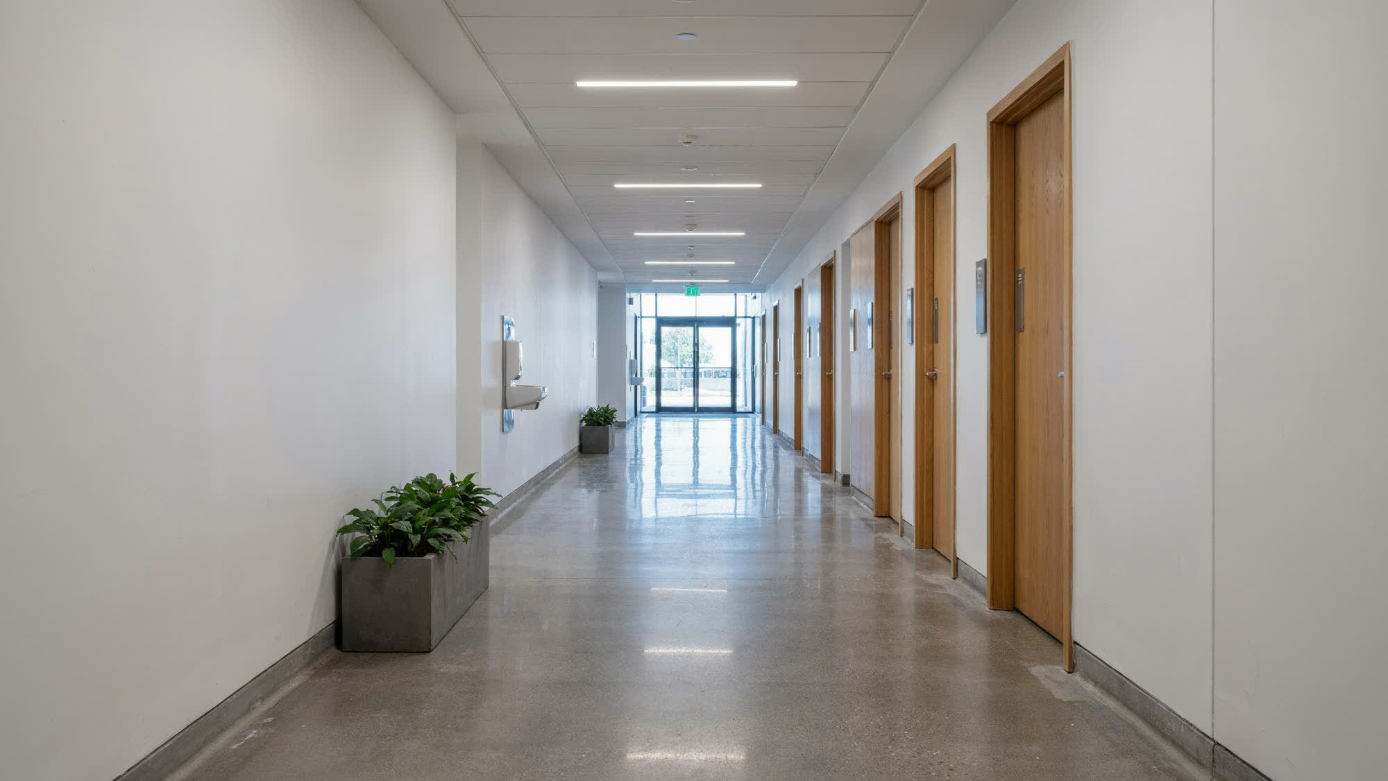 A quiet commercial corridor with daylight at the far end